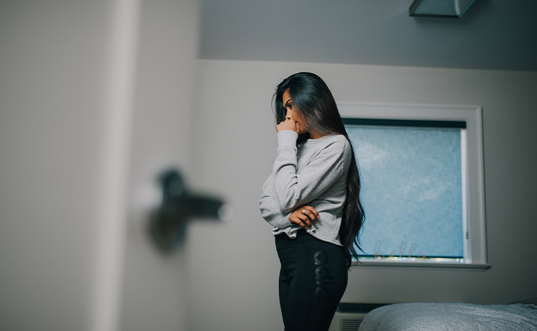 Woman individual in her space grappling with depression consequences.